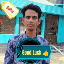 a man stands in front of a blue building with a tag that says bulbul on it