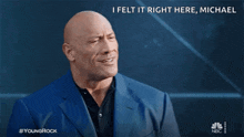 a bald man in a blue suit says " i felt it right here "