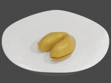 a yellow fortune cookie with a picture of a man and a woman on it