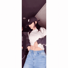 a woman wearing a hat and a crop top with the letters bb on the sleeves