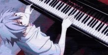 a person is playing a piano with their eyes closed and their hands on the keys .