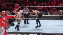 two wrestlers are in a wrestling ring with a referee in the background