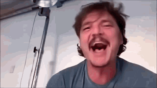 a man with a mustache is making a funny face while talking on a video call .