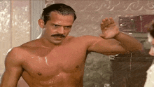 a shirtless man with a mustache is taking a shower