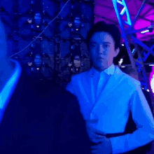 a blurry photo of a man in a blue shirt with the letter s on his chest
