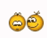 a couple of smiley faces are standing next to each other .