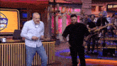 a man dancing in front of a sign that says bar