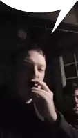 a man wearing a black north face jacket is blowing smoke