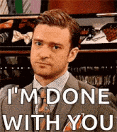 a man in a suit and tie is saying `` i 'm done with you '' while looking at the camera .