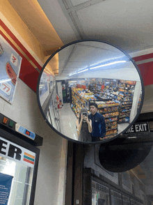a man and woman are taking a picture of themselves in a 7 eleven mirror