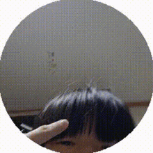 a person 's head is shown in a circle with their finger pointing at it