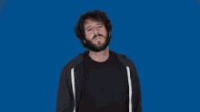 a man stands in front of a blue background that says ewww