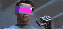 arnold schwarzenegger is wearing a pair of virtual reality glasses and holding a robotic hand