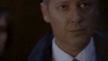 a woman looking at a man holding a gun with the words now ls in red