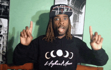 a man wearing a hoodie that says higher moon on it