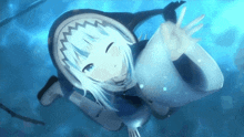 a girl in a shark costume is swimming in the ocean and waving at the camera .