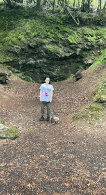 a man standing next to a dog wearing a t-shirt that says " i love you "