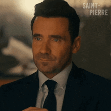 a man in a suit and tie with saint-pierre written on the bottom right