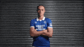 a man wearing a blue jersey with the word unibet on the front