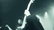 a blurry photo of two men playing guitars on a stage