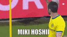 a soccer player in a yellow shirt says miki hoshii