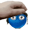 a hand is covering a blue smiley face with a hat and headphones .
