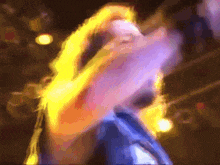 a blurry picture of a person dancing with a yellow background