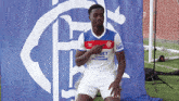 a man in a soccer uniform with a bet logo on his shirt