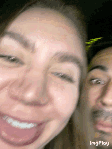 a blurry picture of a man and a woman with the word imgplay at the bottom right
