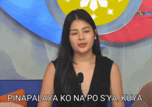 a woman is talking into a microphone with the words pinapalaya ko na po sya kuya written below her