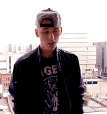a young man wearing a black t-shirt that says age