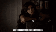 a woman says " don 't piss off the diabolical once " in a dark room