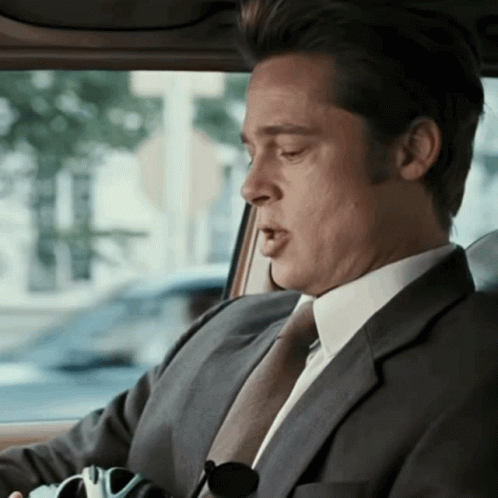 Brad Pitt as Chad Feldheimer in the Coen's Burn After Reading, turns to face someone off camera, "You have the money?"
