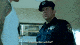 a police officer is asking a man if he has a problem with that