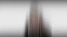 a blurry picture of a person standing in front of a window