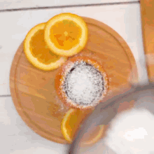 a close up of an orange with powdered sugar on it