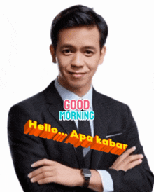 a man in a suit with his arms crossed says good morning hello apa kabar