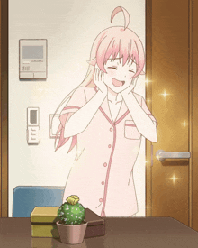 a girl with pink hair is standing in front of a door with a phone on it