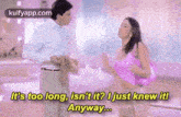 a man and a woman are dancing in a room and the woman is wearing a pink dress .