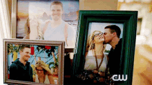 a man and a woman are kissing in a picture frame .