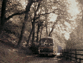 a bus with a license plate that says ' sdm ' on it is driving down a road