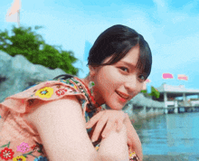 a girl in a pink dress with flowers on it
