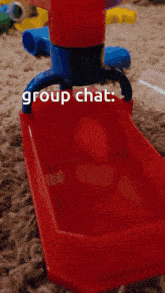 a red and blue toy with the words group chat written on it