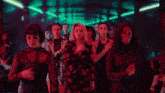 a group of women are dancing in a dark room