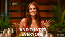 a woman in a red dress is smiling and says and that 's everyone