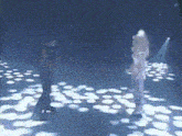 two people are dancing in a dark room with a lot of lights on the floor