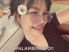 a woman wearing glasses and a flower in her hair says palambling po !!