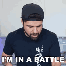 a man wearing a hat and a t-shirt that says " i 'm in a battle "