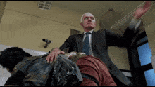 a man in a suit and tie is spanking another man on the butt