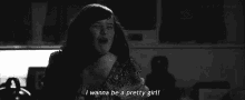 a black and white photo of a woman crying and saying i wanna be a pretty girl .